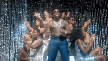 a man is dancing in front of a crowd of women