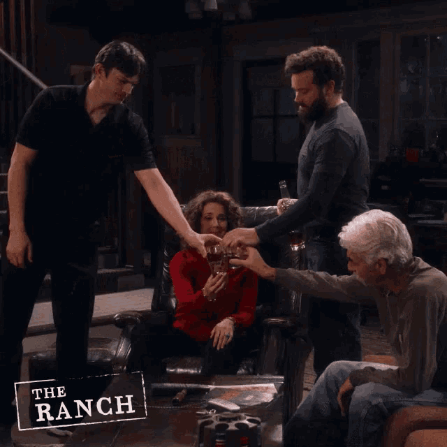a group of people drinking in a living room with a sign that says " the ranch "