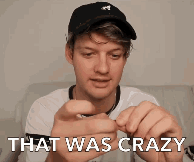 a man wearing a black hat is holding a necklace and the words that was crazy are above him