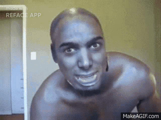 a shirtless man is making a funny face while looking at the camera in a room .