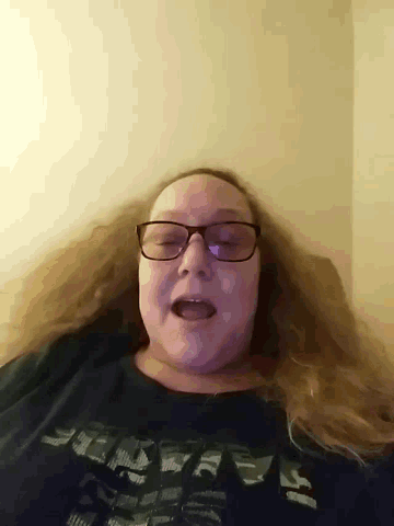 a woman wearing glasses and a shirt that says ' a ' on it