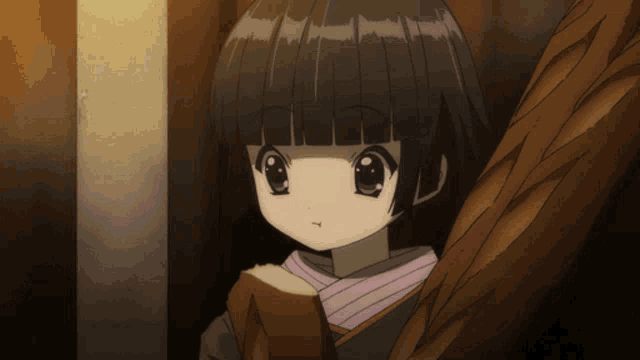 a little girl with black hair is holding a piece of bread in her hand