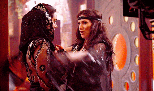 two women are standing next to each other and one has a headband on