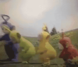 a group of teletubbies standing next to each other on a hill .
