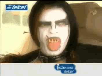 a person with their mouth open and a telcel advertisement in the background