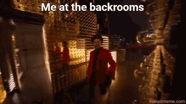 a man in a red jacket is standing in front of a wall with the words me at the backrooms written on it