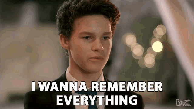 a young man in a suit and tie is saying i wanna remember everything