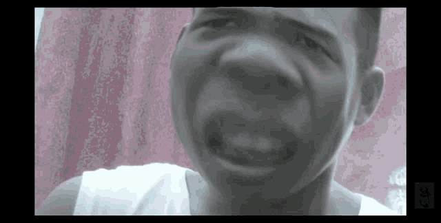a black and white photo of a man making a face