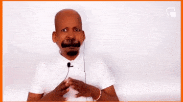 a bald man with a fake mustache is holding a microphone in his hands .