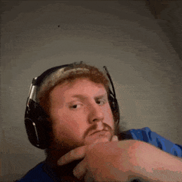 a man with a beard is wearing headphones and a headband