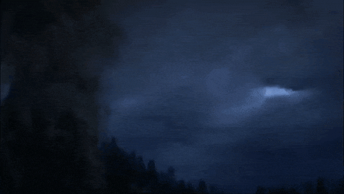 a dragon is flying through the air with a flame coming out of it 's mouth