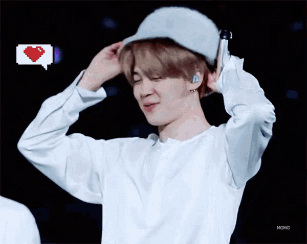 a person wearing a white shirt and a white hat with a pixelated heart in the background