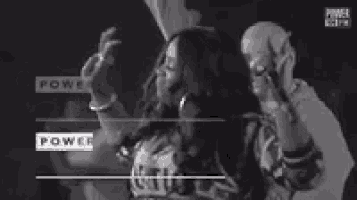 a man and a woman are standing next to each other and pointing at something .