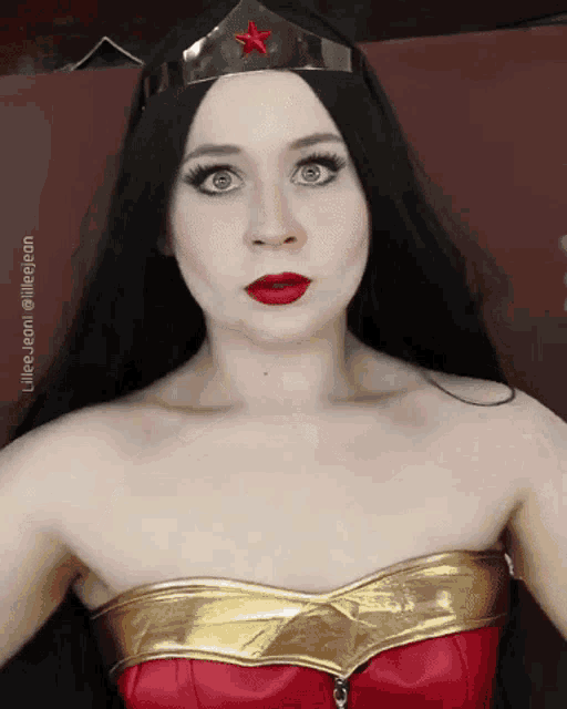 a woman in a wonder woman costume has a red star on her head