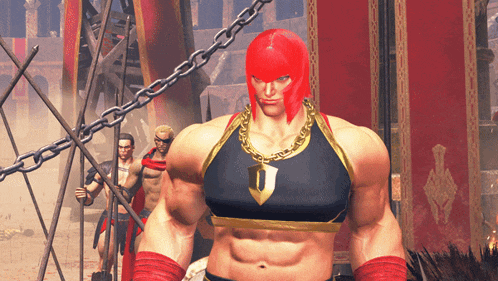 a man with red hair and a gold chain around his neck has the letter j on his shirt
