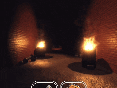 a dark room with two barrels on fire and a brick wall