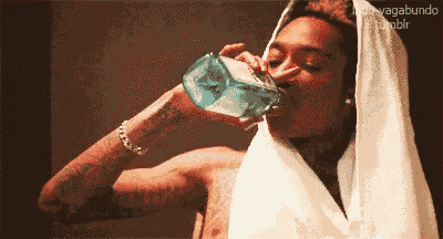 a pixelated image of a man drinking from a glass