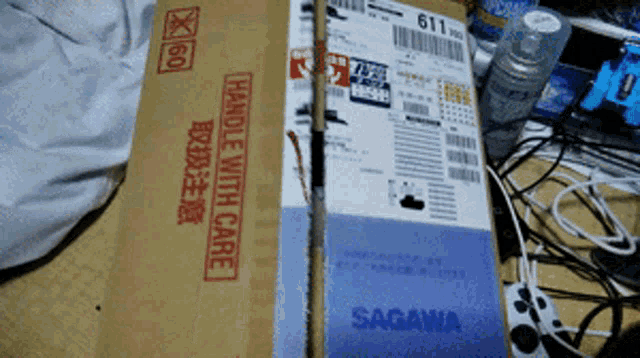 a cardboard box that says handle with care sits on a table