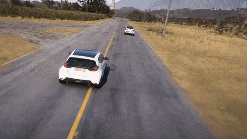 two cars are driving down a road and one has a license plate that starts with the letter r