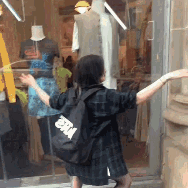 a person standing in front of a store with a bag that says nike on it