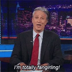 a man in a suit and tie says i 'm totally fangirling .
