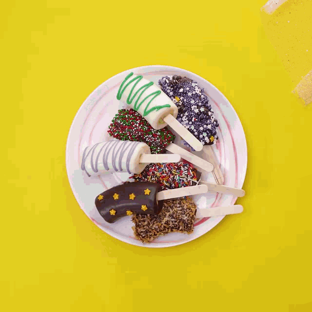 a white plate topped with ice cream covered in sprinkles and chocolate