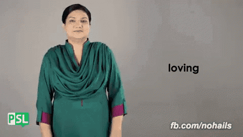 a woman is using sign language to say the word loving .