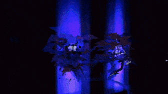 a pixel art of a person with white wings in a dark room