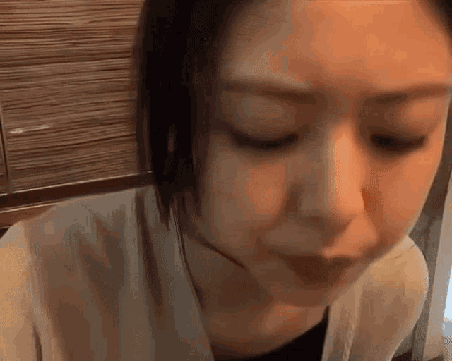 a woman is making a funny face with her mouth open .