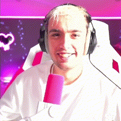 a man wearing headphones and holding a pink microphone