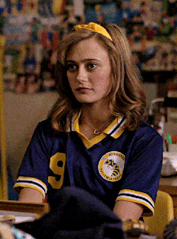 a girl wearing a blue shirt with the number 9 on the front