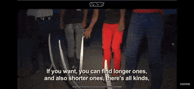 a group of people standing next to each other in a dark room holding sticks .