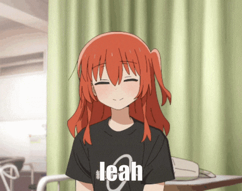 a girl with red hair is wearing a black shirt with the word leah on it