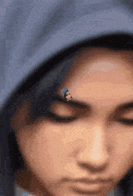 a close up of a person 's face with a picture of a person on their forehead .