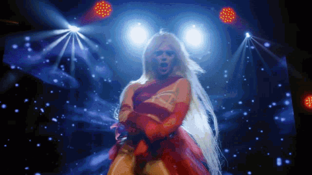 a pixelated image of a woman in a red dress dancing on a stage