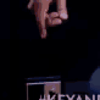 a close up of a person 's hand reaching for something in the dark .