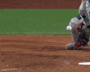 a baseball catcher wearing a nike helmet holds a bat