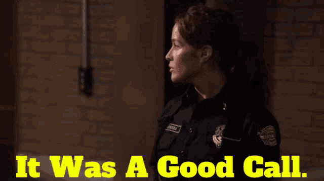 a woman in a police uniform stands in front of a brick wall and says it was a good call