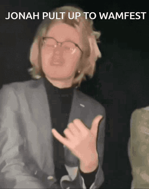 a man in a suit and glasses is making a hand gesture with the words jonah pull up to wamfest above him