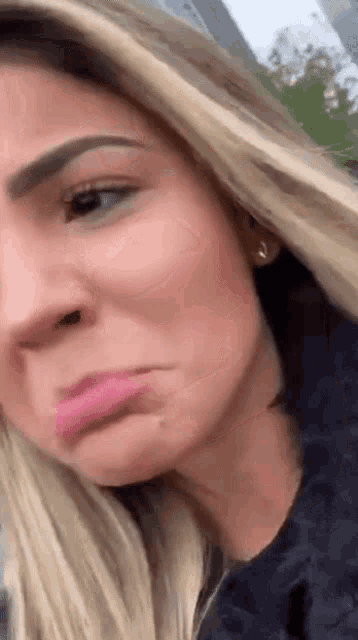 a close up of a woman making a funny face with her lips .