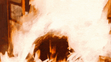 a large fire is coming out of a hole in the ground .