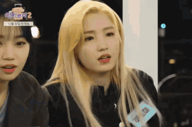 a girl with blonde hair has a name tag that says kwo