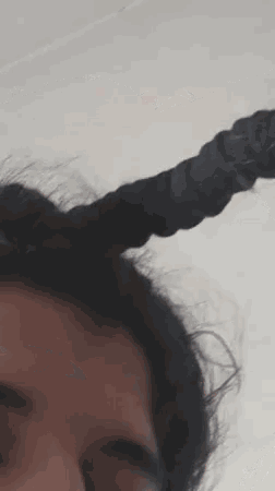 a close up of a person 's head with horns on it .