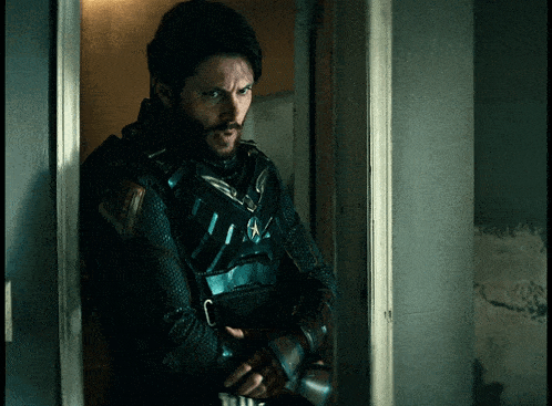 a man in a military uniform with a star on his chest stands in a doorway
