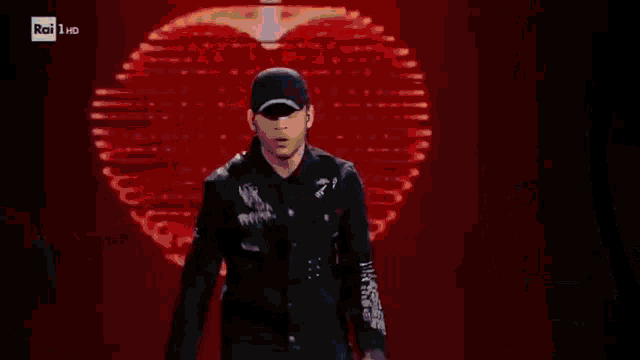 a man in a black shirt is holding a gun