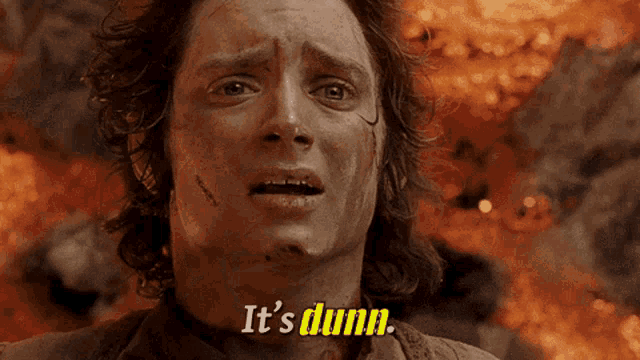 a close up of a man 's face with the words " it 's dunn " behind him