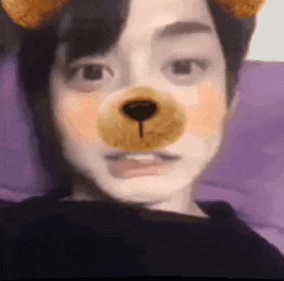a close up of a person wearing a teddy bear mask .