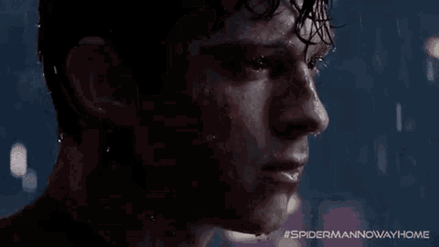 a close up of a man 's face in the rain with water dripping from his eyes .