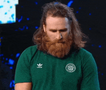 a man with long hair and a beard wears an adidas shirt