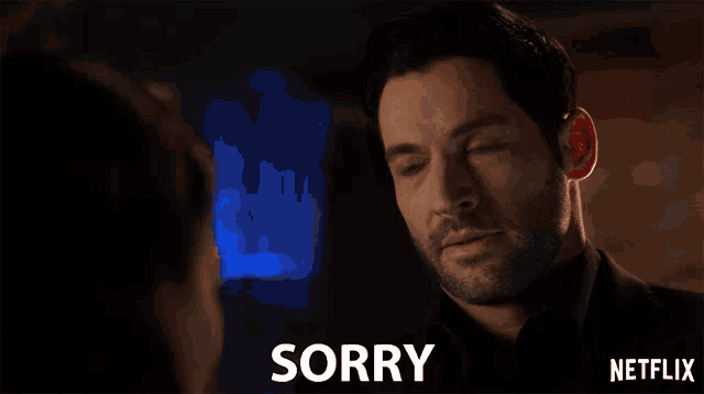 a man with his eyes closed says sorry in front of a woman